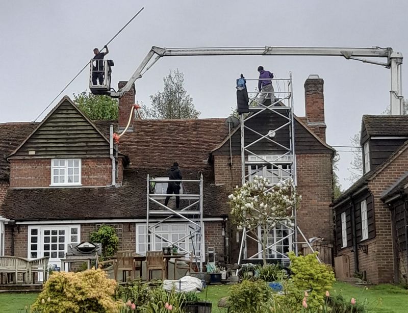 The Roof Moss Cleaners using cherry picker and scaffolding to clean roof safely and professionally in Headley Down, Hampshire