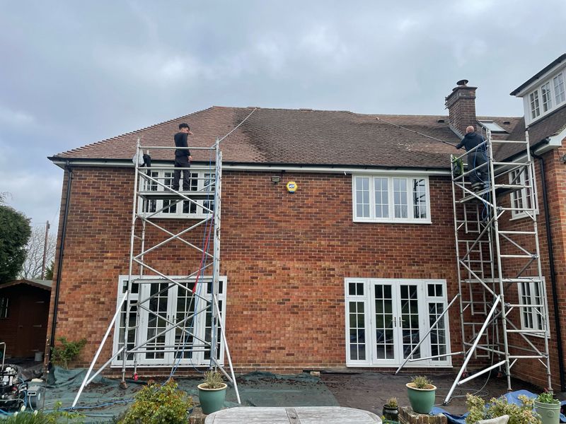 Roof cleaning carried out safely from scaffold towers by The Roof Moss Cleaners in Headley Down